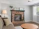 Living room featuring a fireplace and neutral-colored decor, with a comfortable sofa at 20789 E Princeton Pl, Aurora, CO 80013