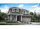 Charming two-story home featuring a brick-accented garage and a covered porch at 12686 W Frost Ave, Littleton, CO 80127