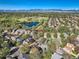 Stunning aerial view of a neighborhood with mature trees, a pond, and mountain views at 10957 Bryant St, Westminster, CO 80234