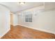 Large finished basement featuring wood-look flooring, sconce lighting, and a window for natural light at 10957 Bryant St, Westminster, CO 80234