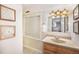 Bathroom with wood vanity, framed mirror, and contemporary art at 10957 Bryant St, Westminster, CO 80234
