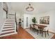 Inviting dining area with hardwood floors, a modern chandelier, and convenient staircase access at 10957 Bryant St, Westminster, CO 80234