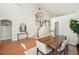 Elegant dining area with hardwood floors, a modern chandelier, and staircase access at 10957 Bryant St, Westminster, CO 80234