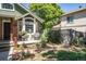 Charming front patio with brick pathway, lush landscaping and comfortable wicker seating area at 10957 Bryant St, Westminster, CO 80234