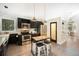 Well-designed kitchen with stainless steel appliances, black cabinetry, and island seating at 10957 Bryant St, Westminster, CO 80234
