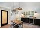 Bright, open kitchen featuring sleek cabinetry, counter seating, and stylish pendant lights at 10957 Bryant St, Westminster, CO 80234