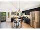 Stylish kitchen boasts dark cabinets, stainless steel appliances, and bright lighting at 10957 Bryant St, Westminster, CO 80234