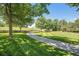Picturesque landscape featuring a walking path that meanders through mature trees and a lush, grassy field at 10957 Bryant St, Westminster, CO 80234