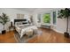 Serene bedroom with large bay windows, hardwood floors, and stylish decor accents at 10957 Bryant St, Westminster, CO 80234