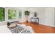 Bright bedroom featuring a cozy bench under bay windows and hardwood floors at 10957 Bryant St, Westminster, CO 80234