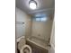 Clean bathroom with a tub, toilet and light gray tile at 12652 E Warren Dr # C, Aurora, CO 80014