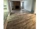 Living room with a stone fireplace and wood-look flooring at 12652 E Warren Dr # C, Aurora, CO 80014
