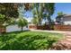 Spacious backyard featuring a lush lawn, mature trees, and detached garage, perfect for outdoor enjoyment at 4197 S Grant St, Englewood, CO 80113