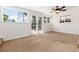 Bedroom with carpet and white walls with windows and glass french doors with view of backyard at 4197 S Grant St, Englewood, CO 80113