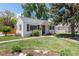 Charming single-story home with a brick walkway, green lawn, and mature landscaping at 4197 S Grant St, Englewood, CO 80113