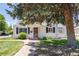 Charming single-story home with a brick walkway, green lawn, and mature landscaping at 4197 S Grant St, Englewood, CO 80113