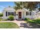 Charming single-story home with a brick walkway, green lawn, and mature landscaping at 4197 S Grant St, Englewood, CO 80113