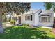 Charming single-story home with a brick walkway, green lawn, and mature landscaping at 4197 S Grant St, Englewood, CO 80113
