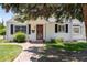 Charming single-story home with a brick walkway, green lawn, and mature landscaping at 4197 S Grant St, Englewood, CO 80113