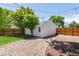 Detached garage with gravel area, trees providing shade and privacy to the outdoor space at 4197 S Grant St, Englewood, CO 80113