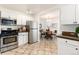 Bright kitchen features stainless steel appliances and access to a dining area at 4197 S Grant St, Englewood, CO 80113
