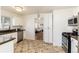 A clean kitchen with white cabinets and stainless steel appliances, complete with tile flooring at 4197 S Grant St, Englewood, CO 80113