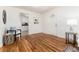 Inviting living room featuring hardwood floors, an arched doorway, and a stylish chair at 4197 S Grant St, Englewood, CO 80113