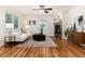 Bright living room features hardwood floors, a ceiling fan, and a stone fireplace at 4197 S Grant St, Englewood, CO 80113