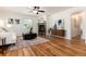 Bright living room features hardwood floors, a ceiling fan, and a stone fireplace at 4197 S Grant St, Englewood, CO 80113