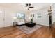 Bright living room features hardwood floors, a ceiling fan, and a stone fireplace at 4197 S Grant St, Englewood, CO 80113