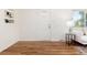 Entryway of a lovely living room features hardwood floors, a white door, and a stylish side table at 4197 S Grant St, Englewood, CO 80113