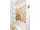 Shower stall features mosaic tile surround, shower head, and window at 4197 S Grant St, Englewood, CO 80113