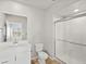 Modern bathroom featuring stylish vanity, a toilet and a glass enclosed shower, creating a clean and spa-like atmosphere at 14451 Pansy Loop, Morrison, CO 80465