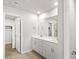 Bright bathroom featuring a double vanity with white cabinets and modern fixtures and a walk-in closet at 14451 Pansy Loop, Morrison, CO 80465