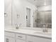 Bathroom featuring double sink vanity with quartz countertop, chrome plumbing fixtures, and glass shower at 14451 Pansy Loop, Morrison, CO 80465