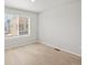 Bright bedroom with a large window offering ample natural light and neutral decor, perfect for relaxation at 14451 Pansy Loop, Morrison, CO 80465