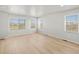 Bright, empty bedroom with hardwood floors and large windows offering natural light at 14451 Pansy Loop, Morrison, CO 80465