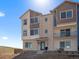 Modern townhome featuring a brick facade and charming balcony, bathed in sunlight on a clear day at 14451 Pansy Loop, Morrison, CO 80465