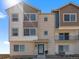 Modern townhome showcasing a brick facade and cozy balcony, illuminated by bright daylight at 14451 Pansy Loop, Morrison, CO 80465