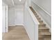 Welcoming hallway with a staircase and neutral tones creating a warm and inviting entry space at 14451 Pansy Loop, Morrison, CO 80465