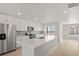 Bright kitchen with white cabinets, stainless steel appliances, and large center island at 14451 Pansy Loop, Morrison, CO 80465
