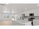 Bright, modern kitchen features a large island, stainless appliances, and sleek white cabinetry at 14451 Pansy Loop, Morrison, CO 80465