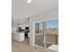 Modern kitchen featuring white cabinets, stainless steel appliances, and a breakfast bar that overlooks the backyard at 14451 Pansy Loop, Morrison, CO 80465