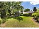 Spacious backyard featuring a lush green lawn with mature trees and landscaping at 2934 S Columbine St, Denver, CO 80210