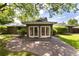 Backyard featuring a stone patio and lush green lawn, with patio doors for indoor/outdoor living at 2934 S Columbine St, Denver, CO 80210