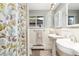 Charming bathroom featuring dual pedestal sinks, tile floors, and a bright window at 2934 S Columbine St, Denver, CO 80210