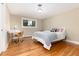 Cozy bedroom with hardwood floors, neutral paint, and a bright window at 2934 S Columbine St, Denver, CO 80210