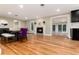 Open floor plan with fireplace and hardwood floors leading into the dining area at 2934 S Columbine St, Denver, CO 80210