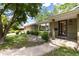 Charming home with stone accents, mature trees, and well-maintained landscaping leading to a covered entrance at 2934 S Columbine St, Denver, CO 80210