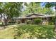 Inviting single-Gathering home featuring mature trees, lush lawn, and a quaint lamp post along the walkway at 2934 S Columbine St, Denver, CO 80210